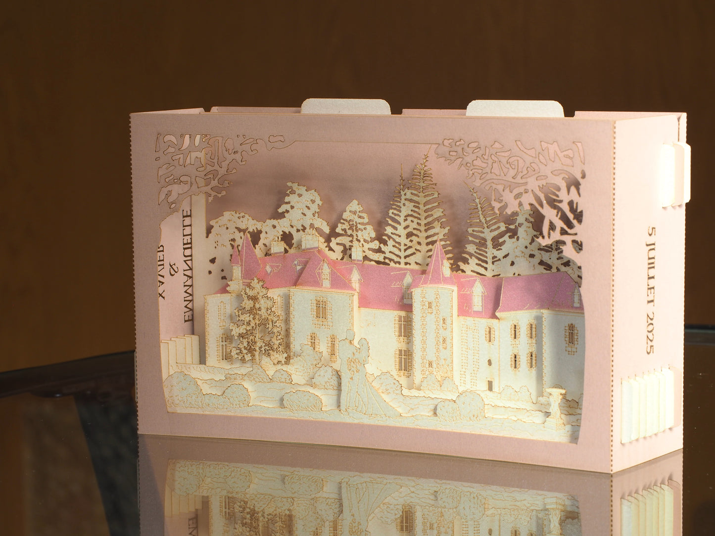 Pop up paper card with pink box and custom laser cut text, wedding invitation that folds flat and has layers inside. Design as a small architecture model of Chateau de Valesne France.