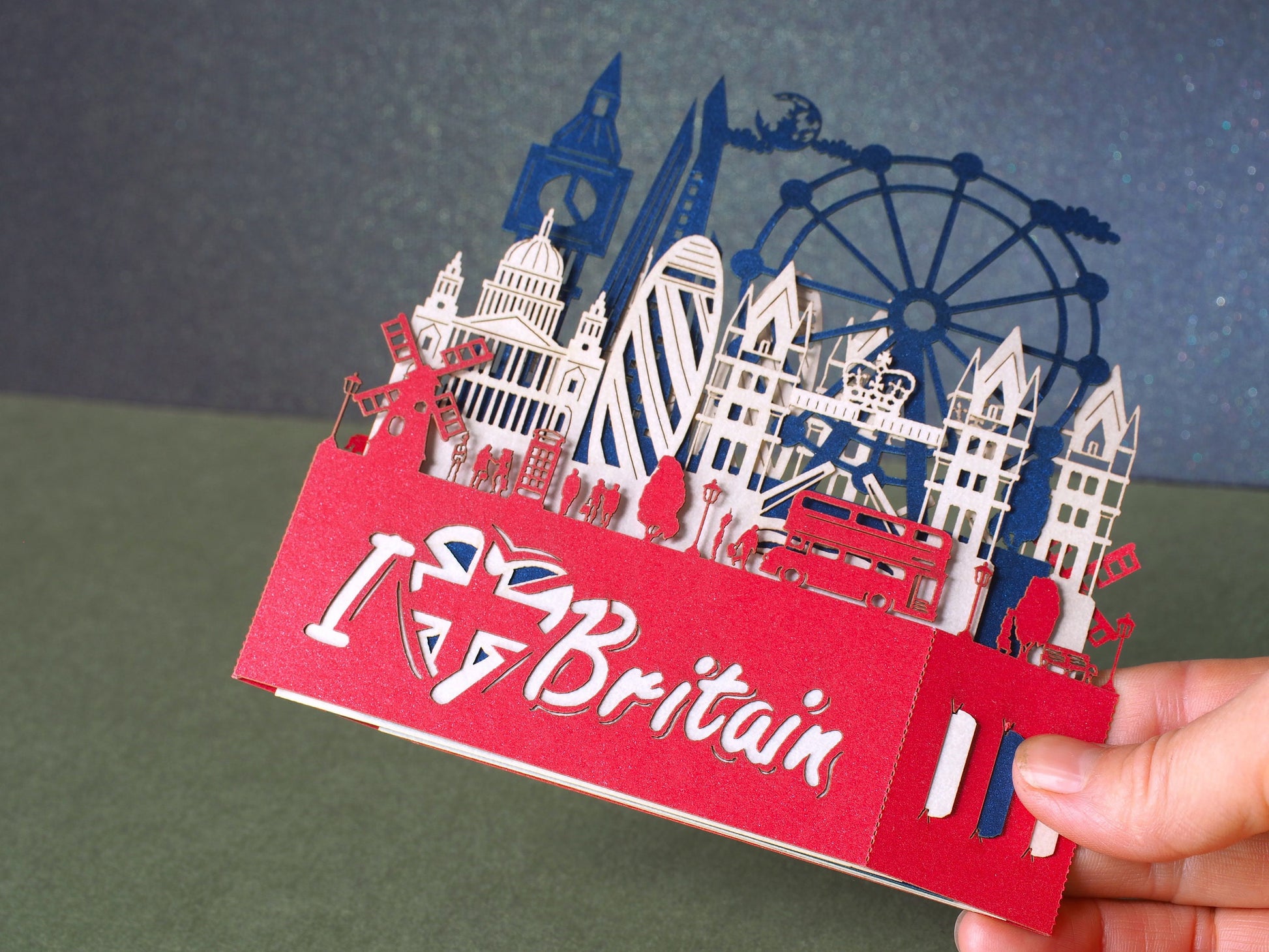 England flag. Paper pop up miniature. English Landmarks. Red Telephone, taxi, bus, Big Ben, Tower Bridge, The Needles, St Paul’s Cathedral