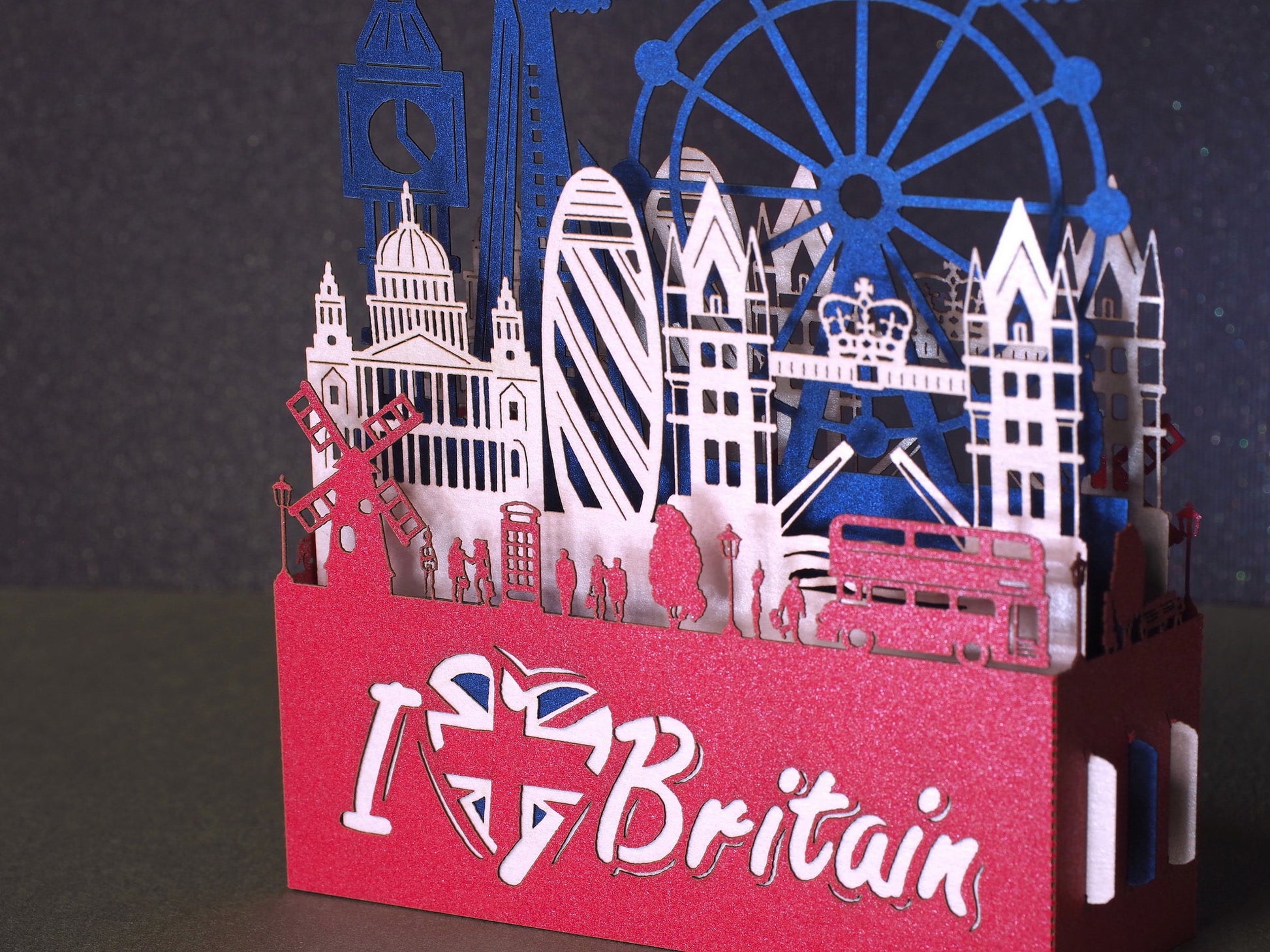 England flag. Paper pop up miniature. English Landmarks. Red Telephone, taxi, bus, Big Ben, Tower Bridge, The Needles, St Paul’s Cathedral