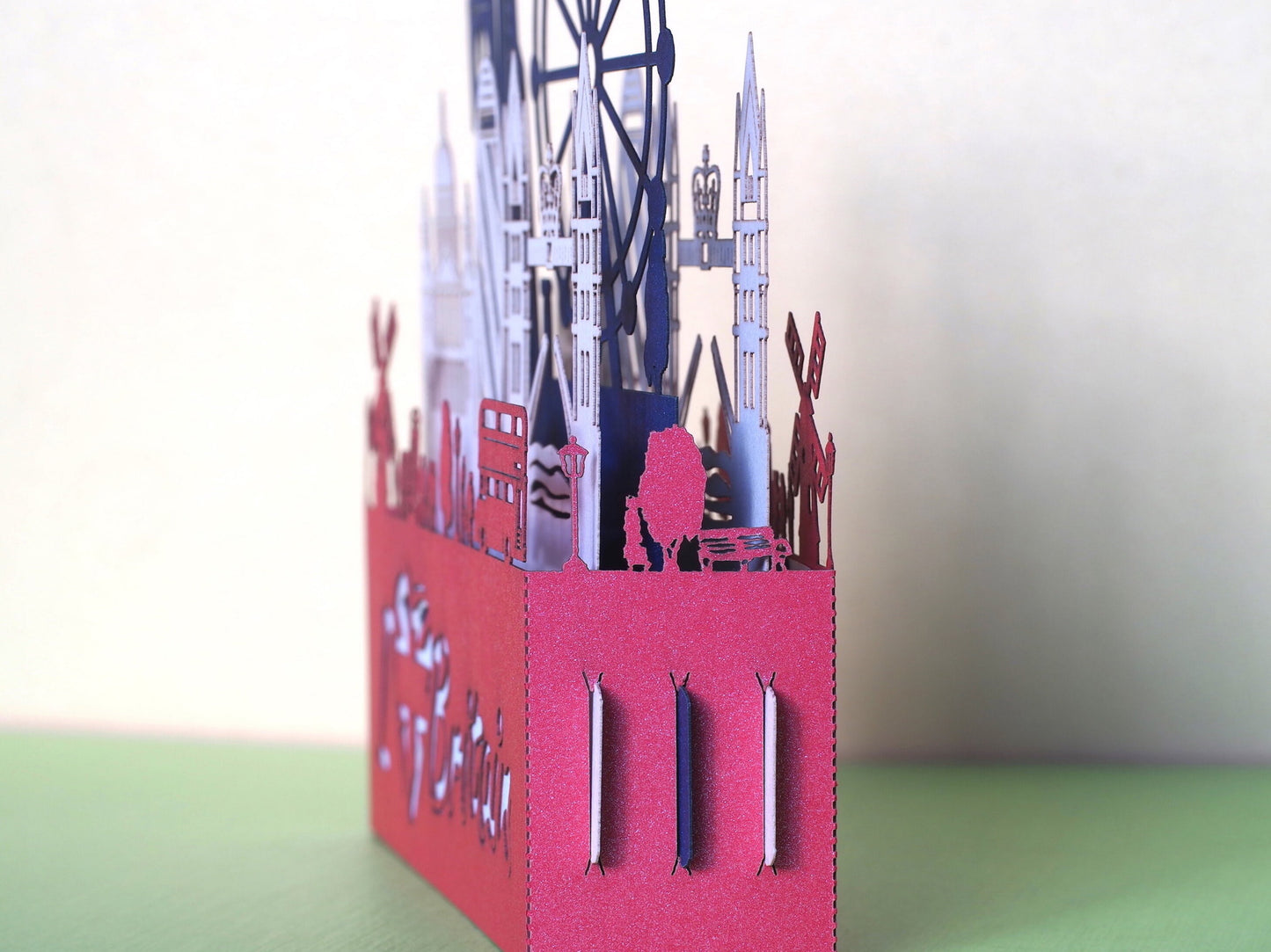 England flag. Paper pop up miniature. English Landmarks. Red Telephone, taxi, bus, Big Ben, Tower Bridge, The Needles, St Paul’s Cathedral