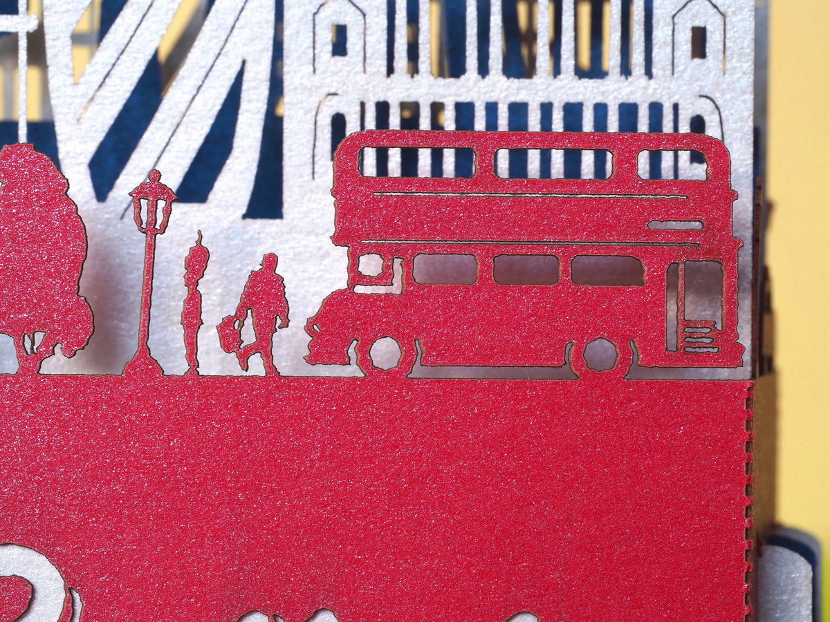 England flag. Paper pop up miniature. English Landmarks. Red Telephone, taxi, bus, Big Ben, Tower Bridge, The Needles, St Paul’s Cathedral