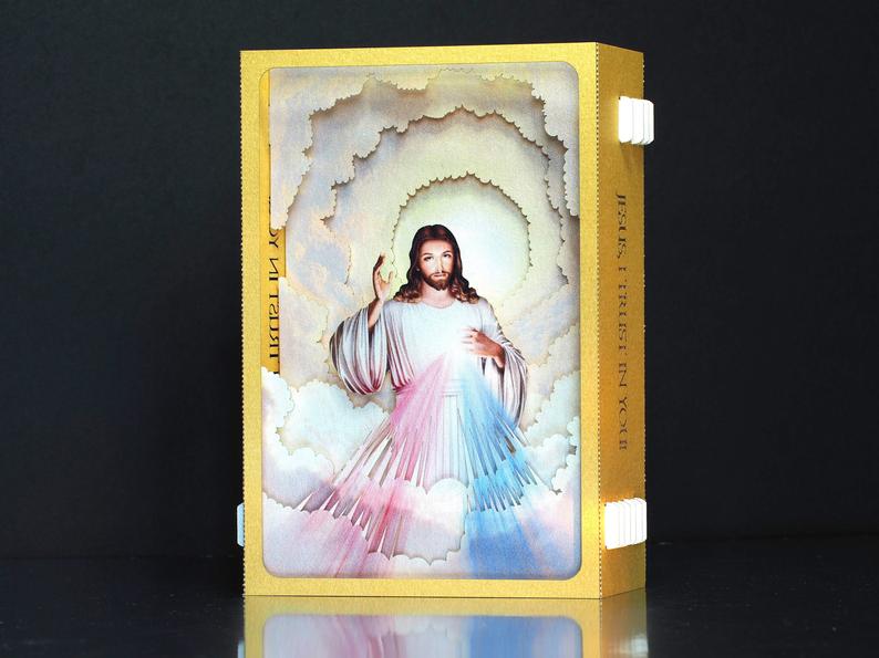 Divine Mercy (Catholic devotion) icon with Jesus - paper pop up card in gold color frame, two  rays- blue and red 